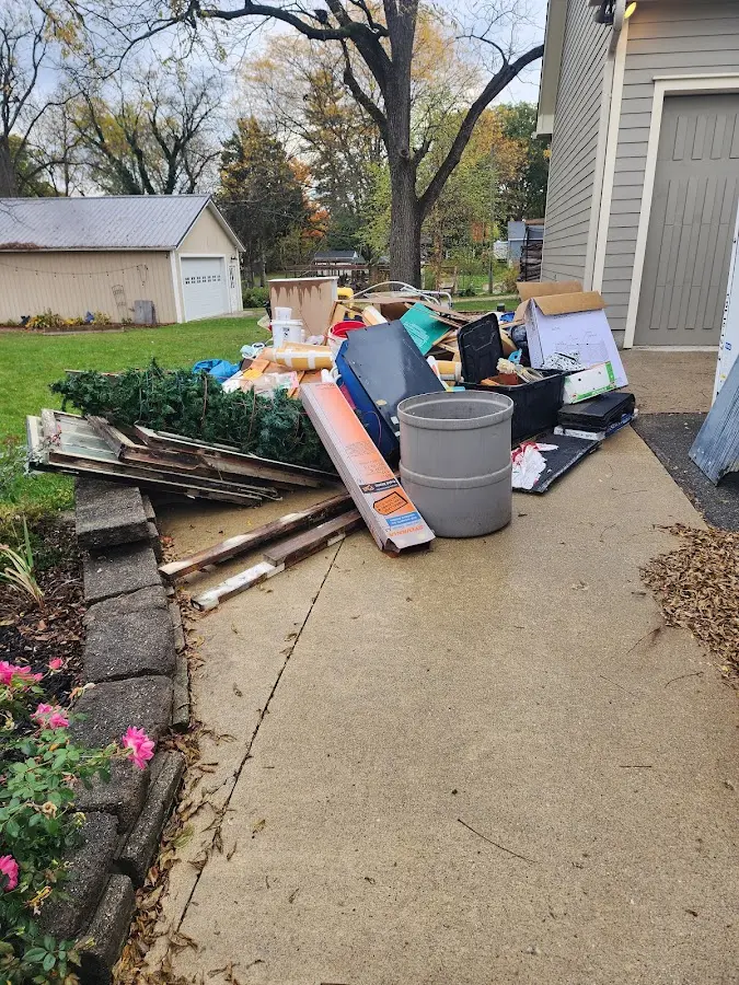 Dumpster being loaded with debris for 3 Yard Dumpster Rental in Demopolis